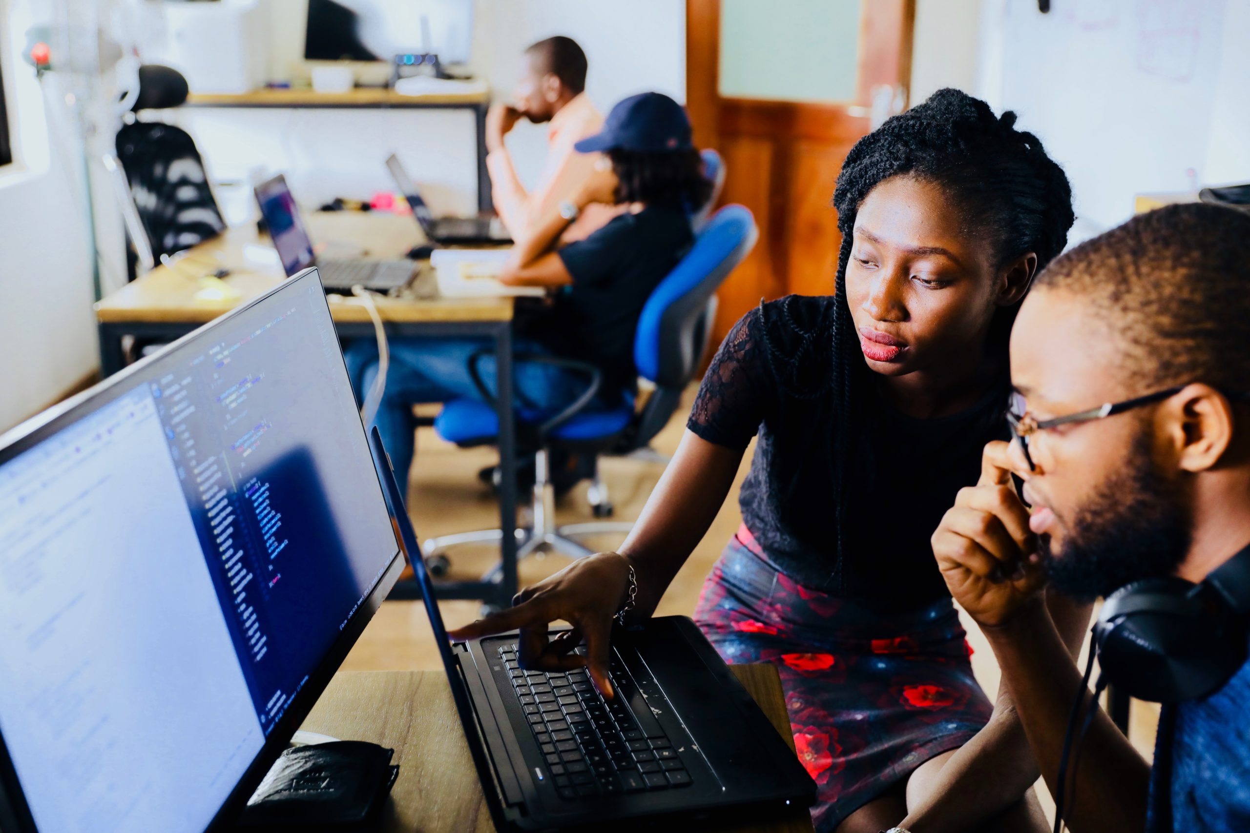 Person helping another person in front of screen